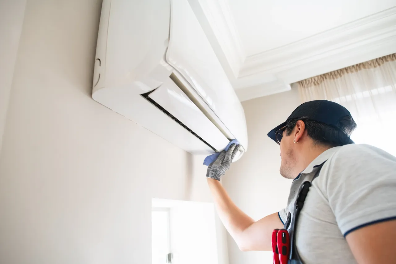 Technician performing air condition installation in a Minnesota home