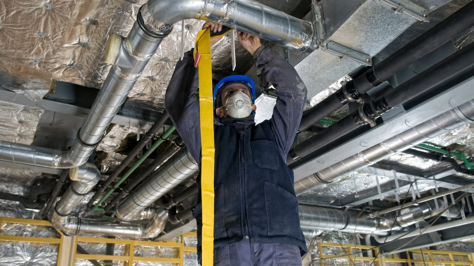 Air duct cleaning and repair under Minnesota | Technician performing air ducts maintenance
