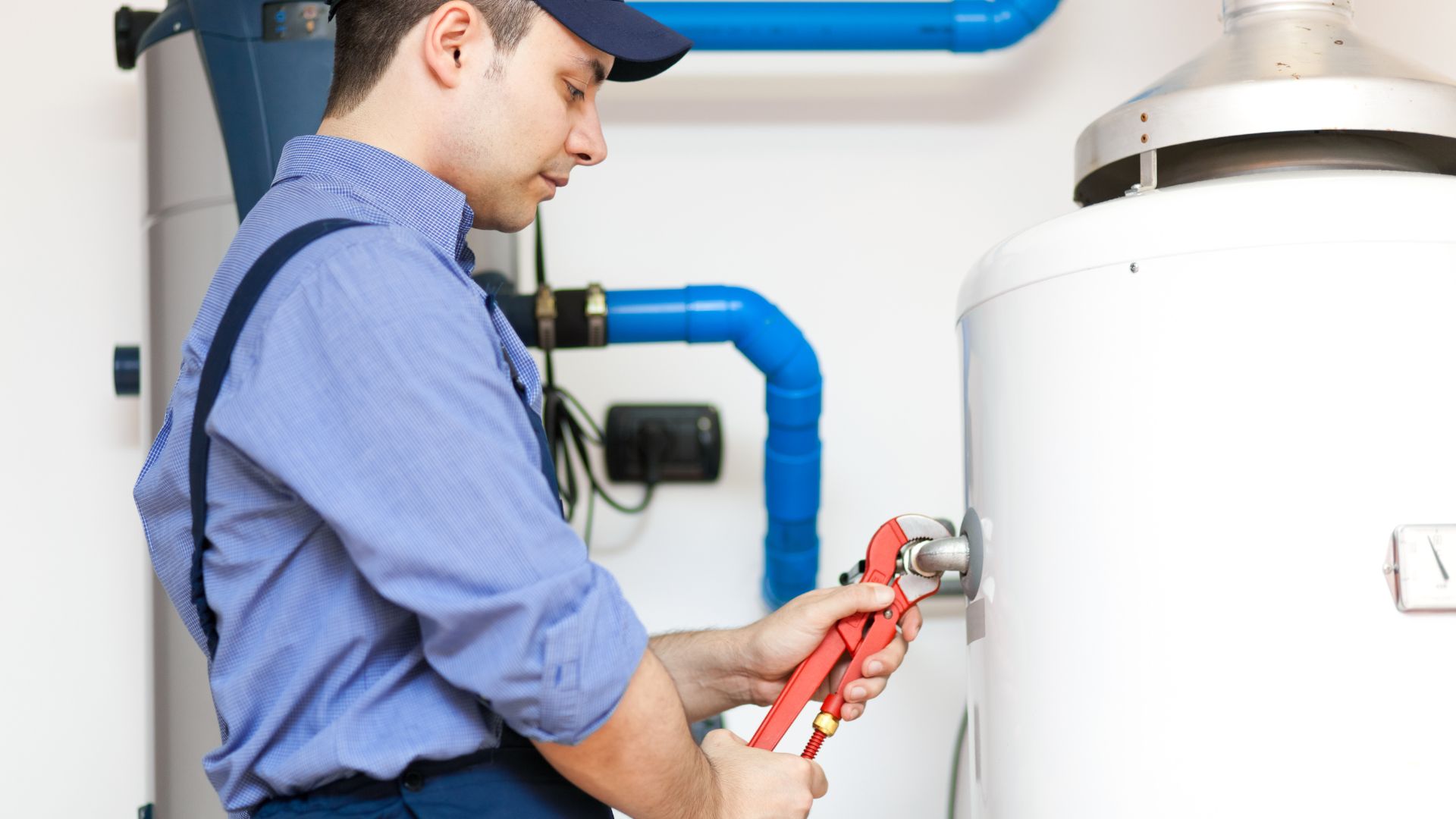 Technician performing water heater repair in a Minnesota home