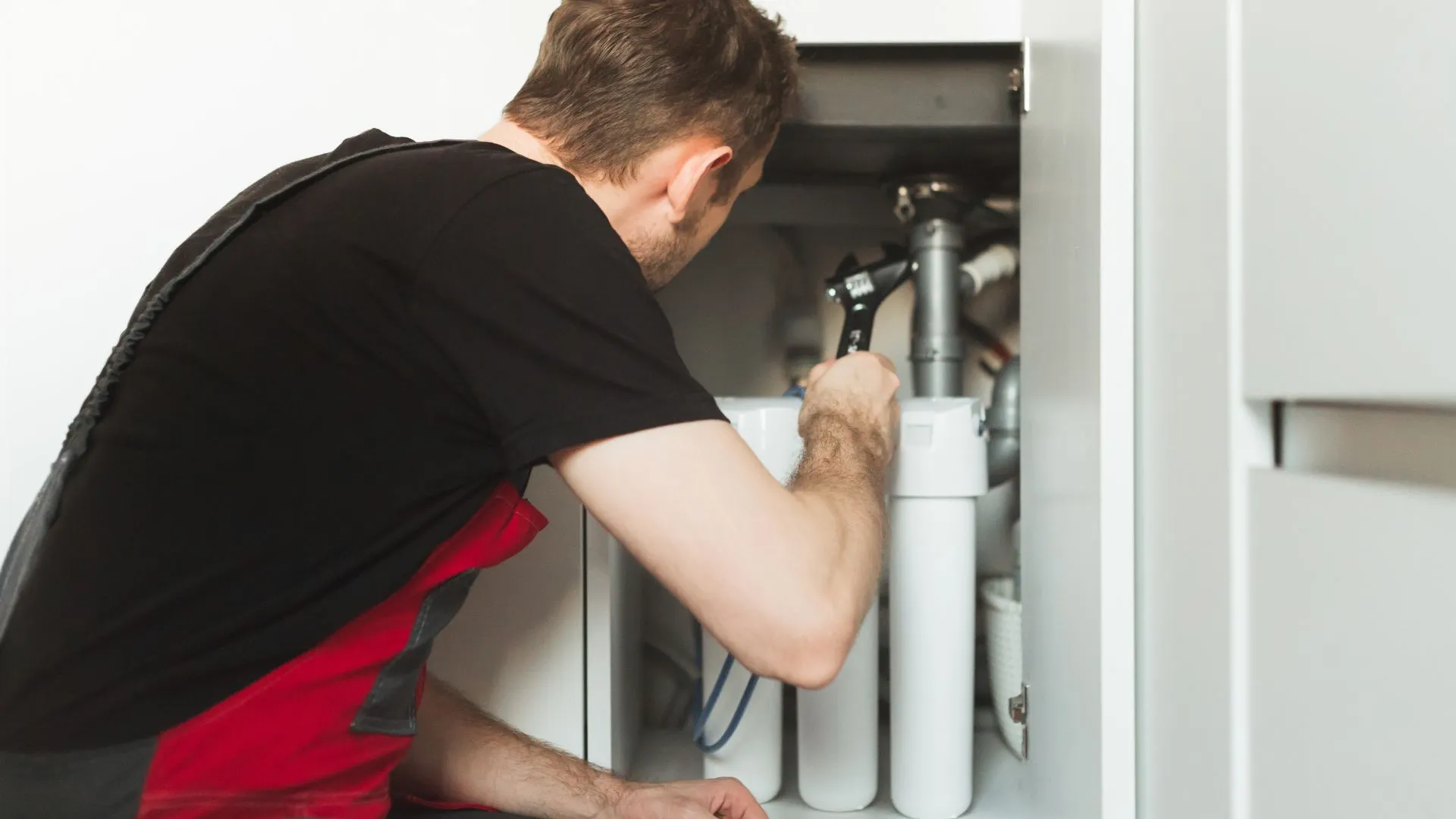 Plumber installing a water softener, water softener repair